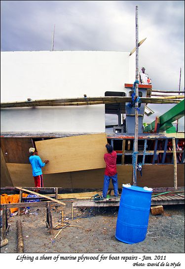 Preparing to put a sheet of marine plywood in place