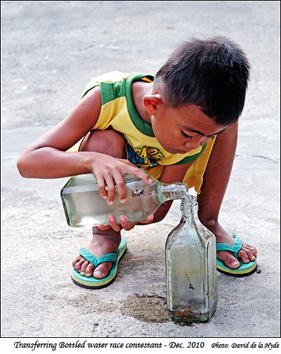 A contestant in a Transferring bottled water race