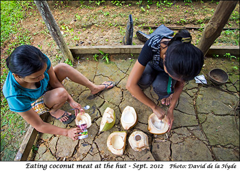 Eating coconut meat at the hut