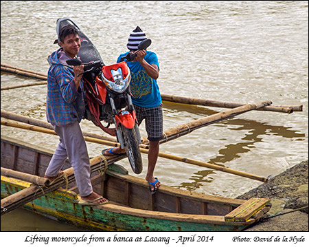 Lifting a motorcycle from a banca at Laoang