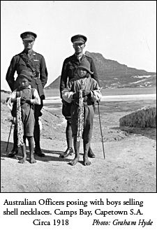Australian Officers posing with boys selling shell neclaces - Capetown circa 1918