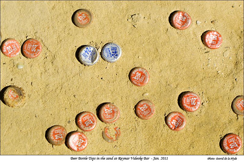 Bottle tops in the sand at Reymar Videoke and Bar