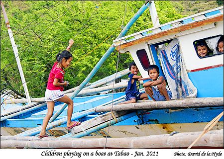 Some children playing on a boat at Tabao