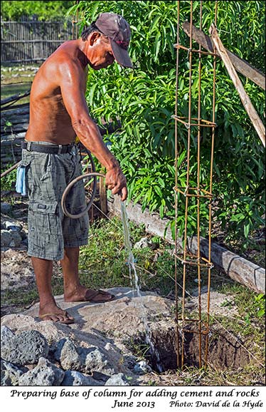 Hosing the base of a column in preparation for cement to be added